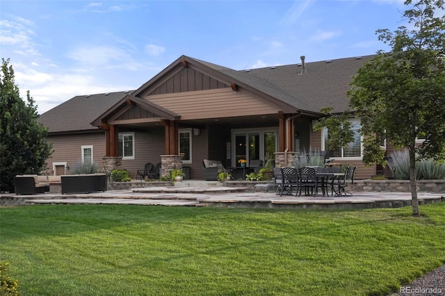 rear view of property with an outdoor hangout area, a lawn, and a patio area