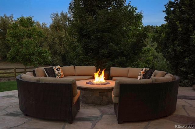 patio terrace at dusk featuring an outdoor living space with a fire pit