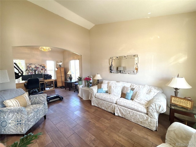 2835 S Tower Way, Aurora, CO 80013 - living room with arched walkways, wood finished floors, and high vaulted ceiling