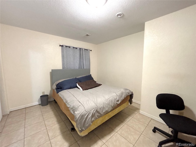 2835 S Tower Way, Aurora, CO 80013 - bedroom with light tile patterned floors, baseboards, and a textured ceiling