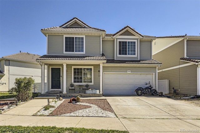 20530 Randolph Pl, Denver, CO 80249 - view of front of property featuring a tile roof, covered porch, concrete driveway, and an attached garage