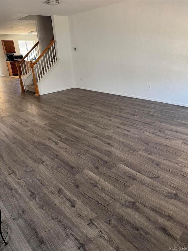 20530 Randolph Pl, Denver, CO 80249 - unfurnished room with dark wood-type flooring and stairs
