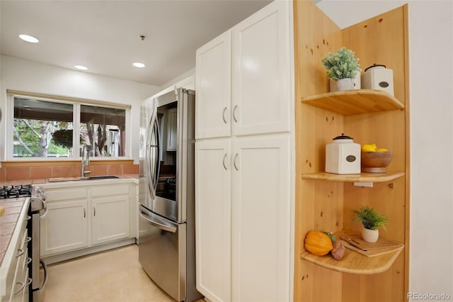 1460 Quince Ave Unit 102, Boulder, CO 80304 - kitchen with stainless steel appliances, open shelves, tile counters, white cabinetry, and recessed lighting