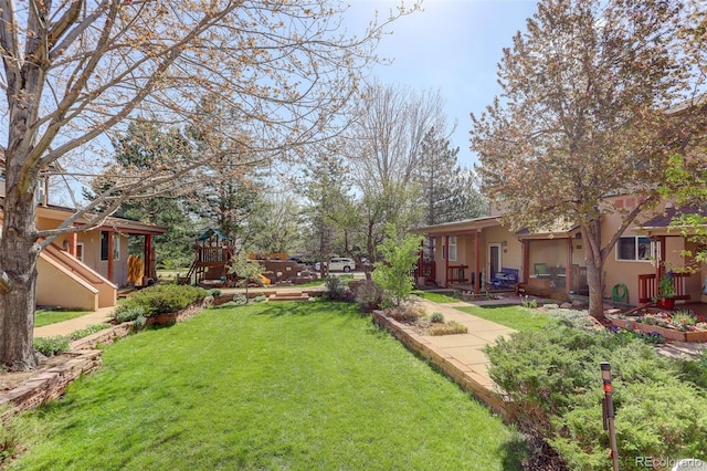 1460 Quince Ave Unit 102, Boulder, CO 80304 - view of grassy yard with a playground and a patio area