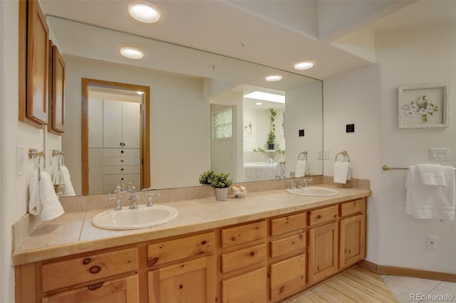 1460 Quince Ave Unit 102, Boulder, CO 80304 - bathroom featuring double vanity and a bath