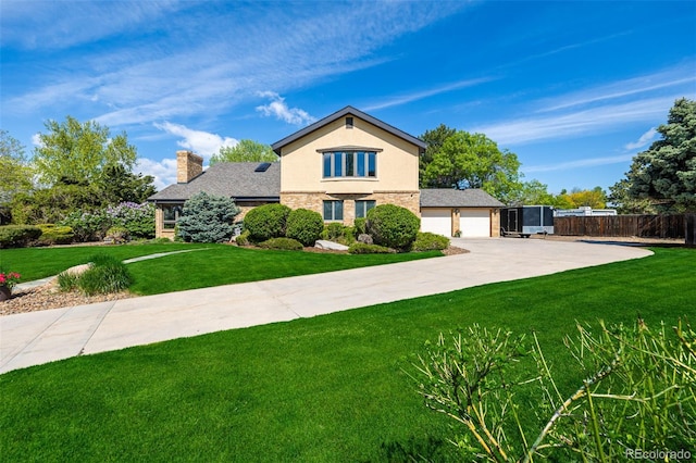 traditional-style house with an attached garage, fence, concrete driveway, a chimney, and a front yard