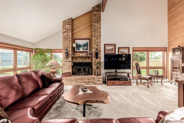 carpeted living room featuring high vaulted ceiling, a fireplace, wooden walls, and baseboard heating