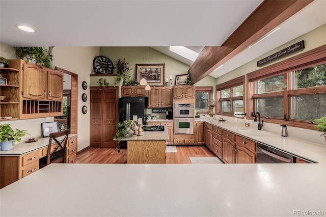 kitchen featuring lofted ceiling with beams, a sink, black appliances, light wood-type flooring, and open shelves