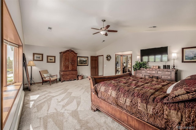 bedroom featuring a baseboard heating unit, lofted ceiling, light colored carpet, and visible vents