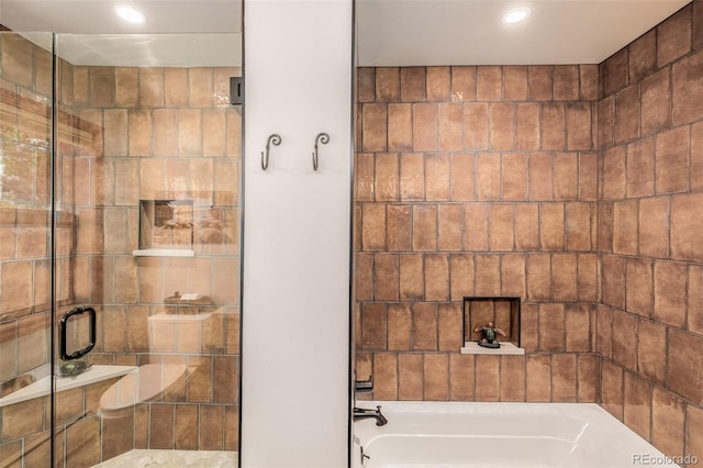 bathroom with a washtub, a stall shower, and recessed lighting