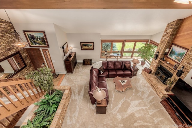 carpeted living area featuring a brick fireplace, stairway, and baseboards