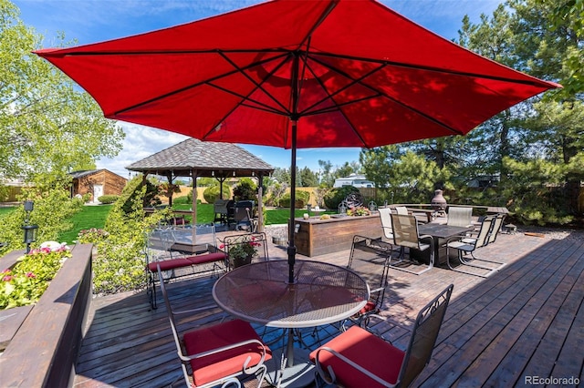 wooden terrace with a gazebo and outdoor dining space