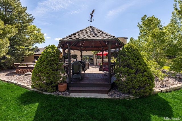 wooden terrace with a yard and a gazebo