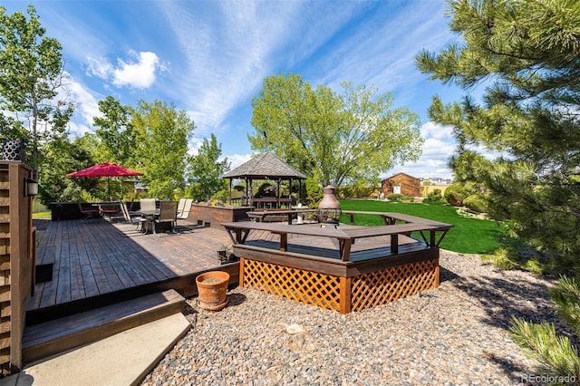 wooden deck with outdoor dining space and a gazebo