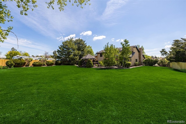 view of yard with a gazebo and fence