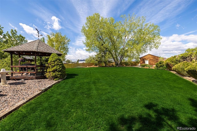 view of yard with a fenced backyard and a gazebo