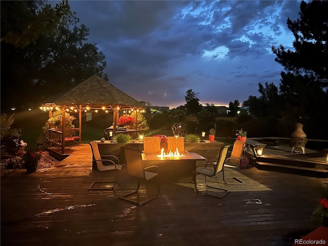 deck with a fire pit and a gazebo