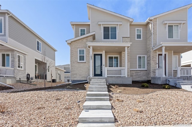 view of front of home featuring stone siding and a porch