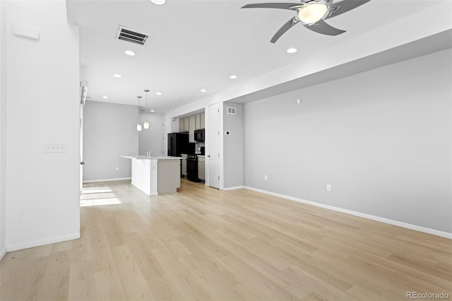 unfurnished living room with light wood finished floors, recessed lighting, visible vents, ceiling fan, and baseboards