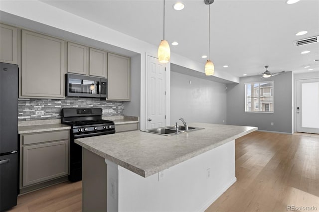 kitchen with black appliances, visible vents, gray cabinets, and a sink