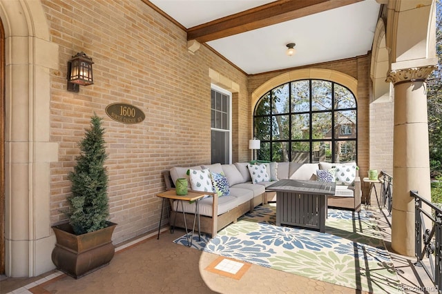 sunroom / solarium featuring beamed ceiling