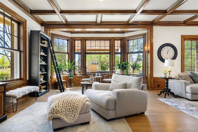 sitting room with ornamental molding, coffered ceiling, beam ceiling, and light hardwood / wood-style flooring