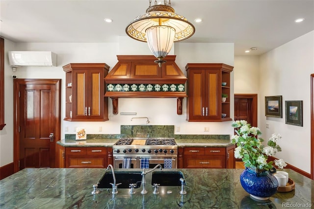 kitchen featuring pendant lighting, a wall mounted AC, high end stainless steel range, and dark stone countertops