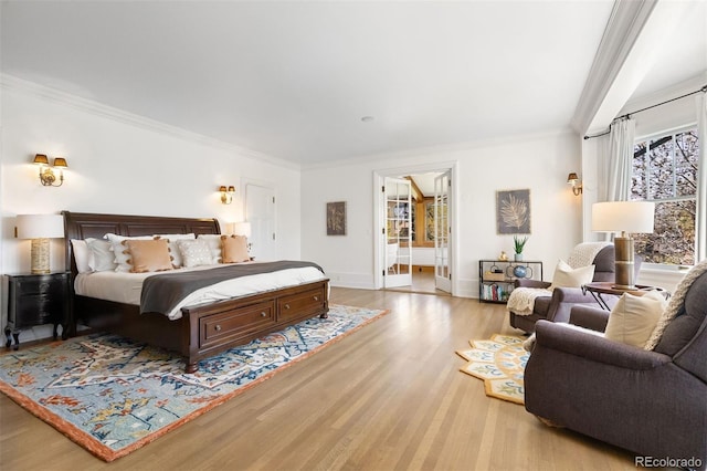 bedroom featuring crown molding and light wood-type flooring