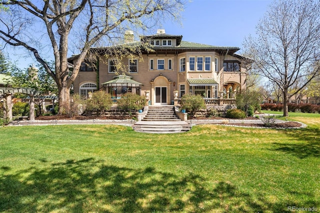 mediterranean / spanish-style home with a front yard