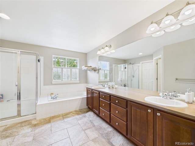 10497 Wagon Box Cir, Highlands Ranch, CO 80130 - bathroom featuring double vanity, a bath, and a stall shower