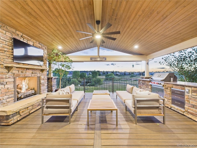 10497 Wagon Box Cir, Highlands Ranch, CO 80130 - deck featuring an outdoor living space with a fireplace, exterior kitchen, and ceiling fan