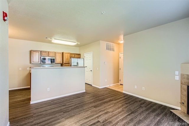 kitchen featuring visible vents, dark wood-type flooring, baseboards, and appliances with stainless steel finishes
