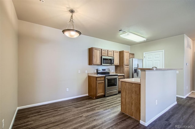 kitchen featuring baseboards, light countertops, dark wood-style floors, and stainless steel appliances