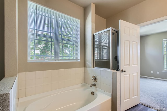 full bath featuring a shower stall and a bath
