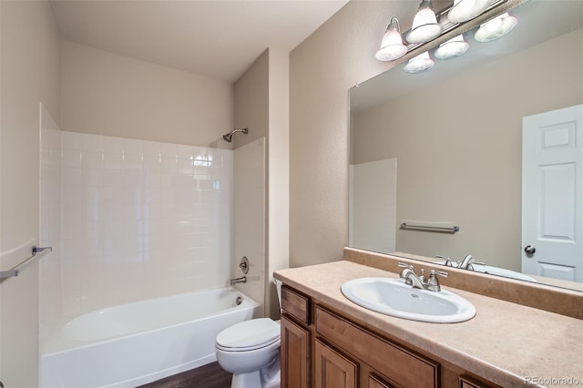 bathroom featuring toilet, bathtub / shower combination, wood finished floors, and vanity