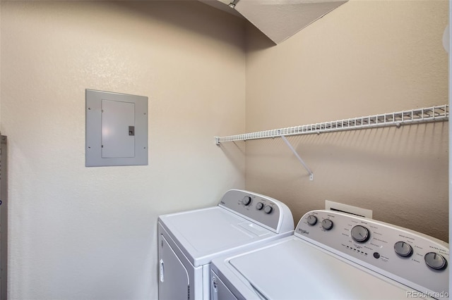 clothes washing area with separate washer and dryer, laundry area, and electric panel