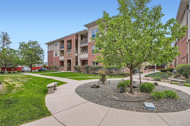 view of home's community with a lawn
