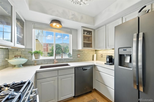 911 Laramie Blvd Unit B, Boulder, CO 80304 - kitchen featuring appliances with stainless steel finishes, light countertops, white cabinetry, and light wood-type flooring