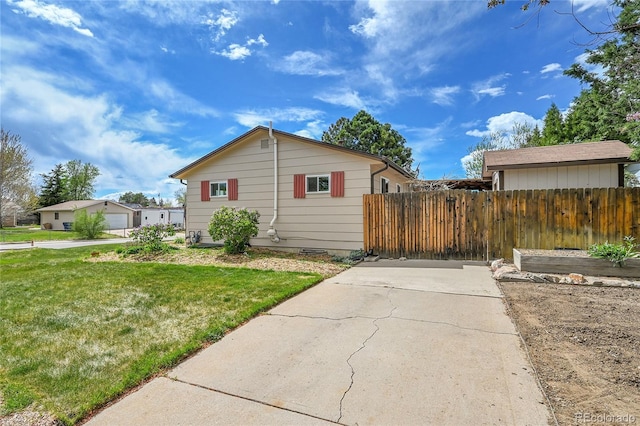 3451 Highland Pl, Westminster, CO 80031 - view of front of home featuring fence, driveway, and a front yard