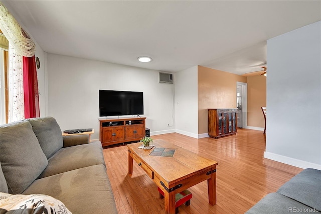 3451 Highland Pl, Westminster, CO 80031 - living room featuring light wood-style floors, baseboards, and an AC wall unit