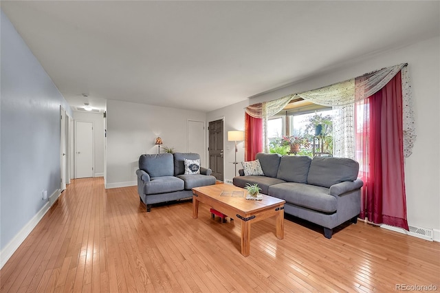3451 Highland Pl, Westminster, CO 80031 - living area with baseboards, visible vents, and light wood-style flooring