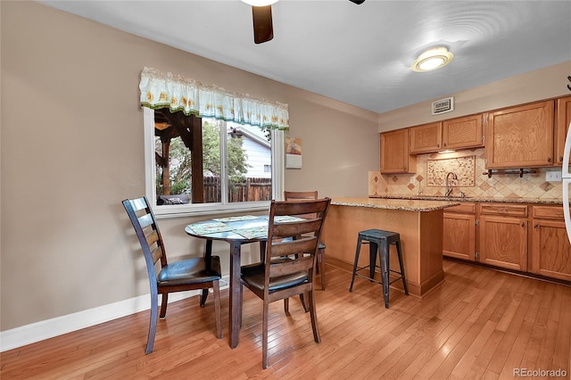 3451 Highland Pl, Westminster, CO 80031 - dining room featuring visible vents, light wood finished floors, ceiling fan, and baseboards