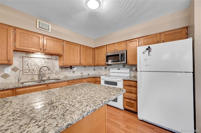 3451 Highland Pl, Westminster, CO 80031 - kitchen with tasteful backsplash, light stone countertops, a sink, white appliances, and light wood-style flooring