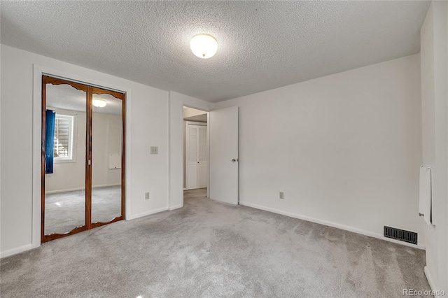 3451 Highland Pl, Westminster, CO 80031 - unfurnished bedroom with a textured ceiling, visible vents, baseboards, a closet, and carpet
