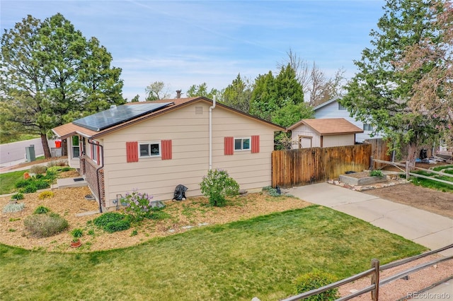3451 Highland Pl, Westminster, CO 80031 - view of home's exterior featuring fence, a garden, a yard, and solar panels