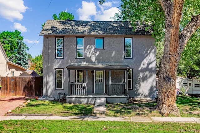 view of front of home with a front yard and covered porch