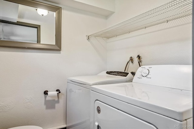 clothes washing area featuring washer and dryer