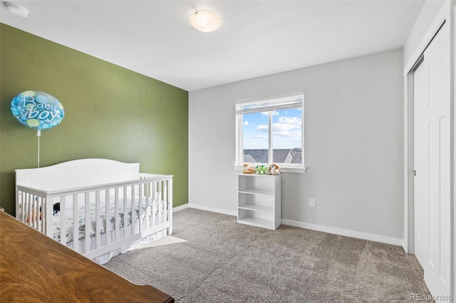 unfurnished bedroom with carpet floors, a closet, and baseboards