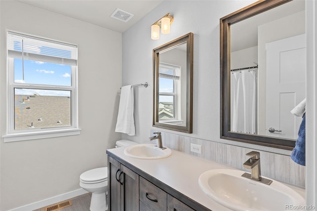 full bath with plenty of natural light, visible vents, and a sink