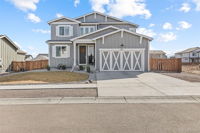 view of front facade featuring driveway, an attached garage, fence, and board and batten siding